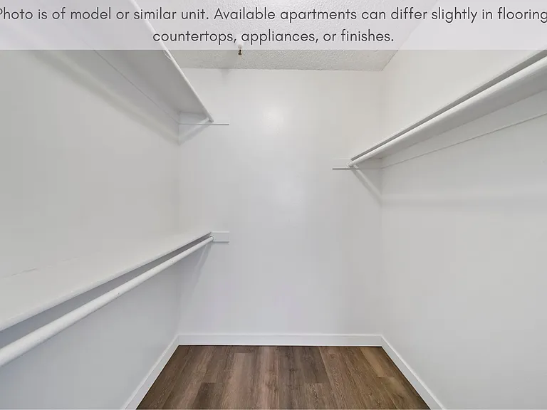 Walk-in closet featuring generous storage with built-in shelving and hanging space.