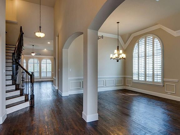 Hand scraped solid oak floors throughout first floor living areas. Custom arched plantation shutters completing high end finish out.