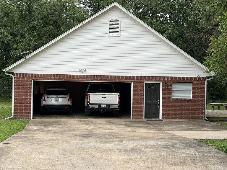 Garage fits 2 vehicles, including a large truck.