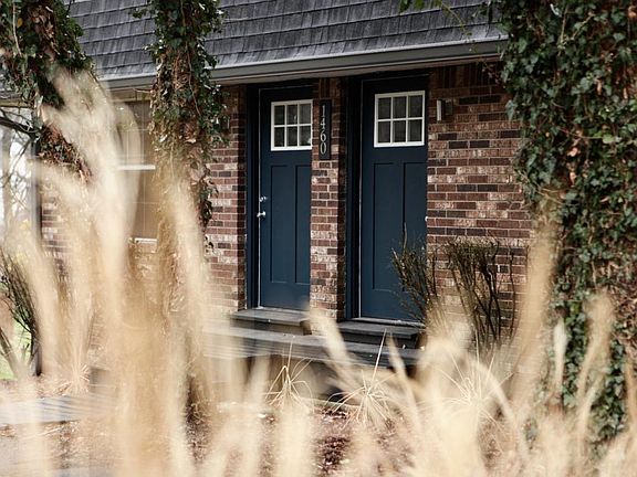 front, new landscaping on treed lot 