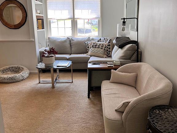 Living room with plentiful room & built in shelving
