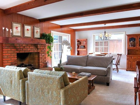 Bright living room with gorgeous brick fireplace