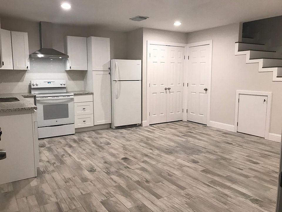 Kitchen and living room view with half bath and laundry facility.
