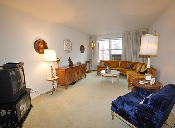 The large sunny living room opens to the large dining foyer.