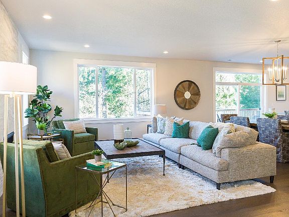 Great room with bright green space views