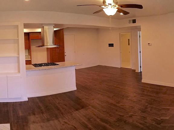 Living room, kitchen, dining, staircase with skylight.