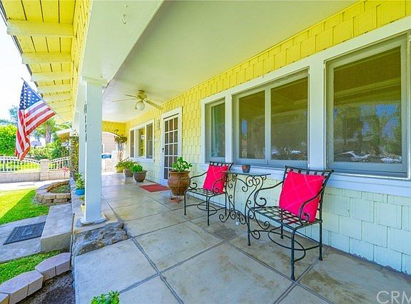 Long covered porch with ceiling fan light