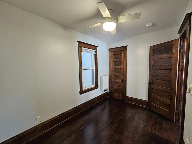 Front bedroom is connected through the dining room. Room measures 138"x91" with closet and ceiling fan. Due to close proximity of the neighboring property, bedroom has privacy glass to allow sunshine in and provide personal security.