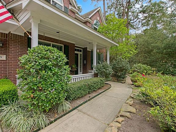Wooded corner lot provides privacy and enjoyments of nature.  Beautiful and inviting walkway to front door entrance.