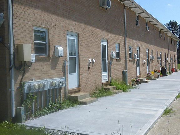 Rear entrance at parking lot. Unit available is last unit on far right. Each unit has 2 assigned parking spaces.