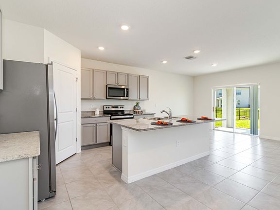 Bright Sunny Kitchen with Granite Countertops and Stainless Steel Appliances