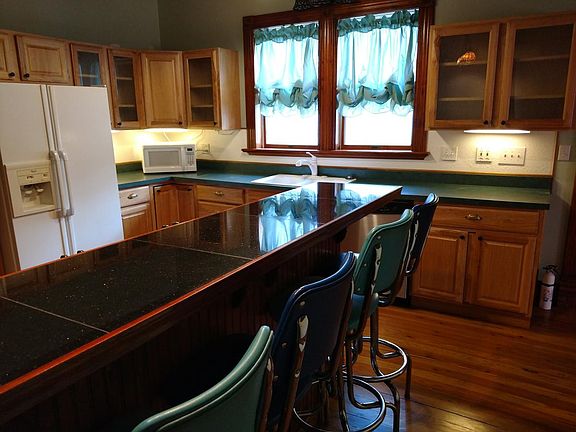 Kitchen with breakfast bar, hickory cabinets and under cabin