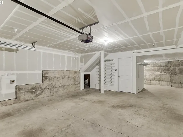 Two car garage with lots of storage in the back