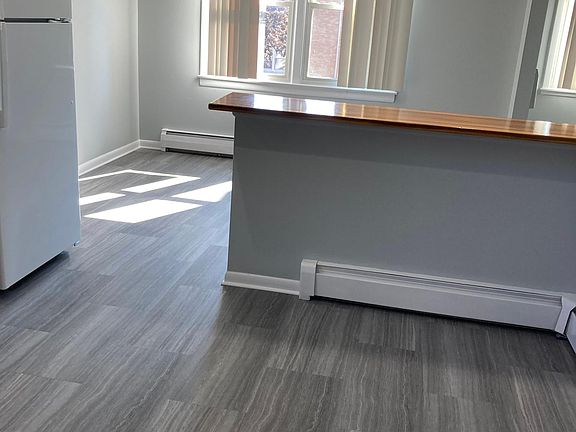 New floor in kitchen and dining area. Window treatments are not provided.