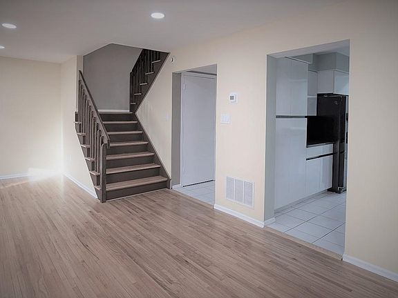 Wood Staircase to second home level of three bedroom & 2 full bathrooms.