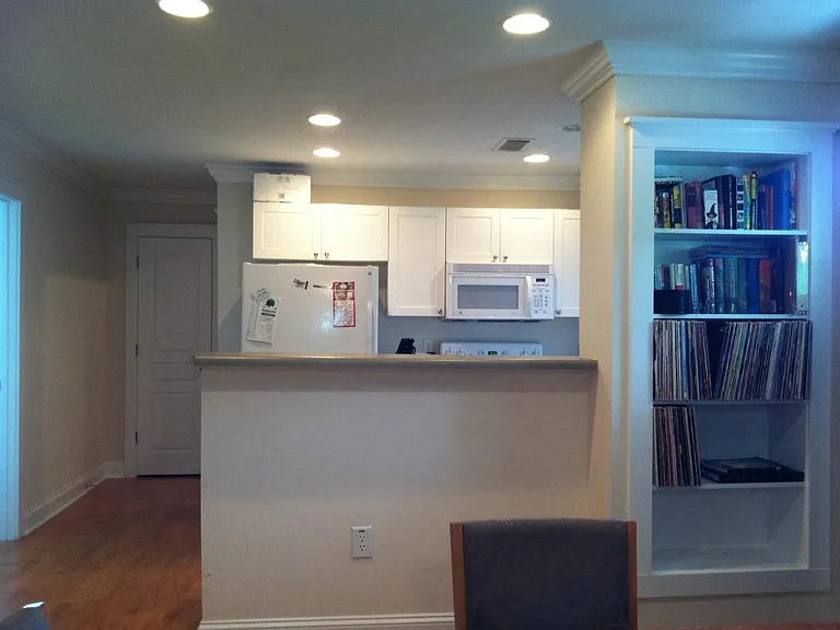 View of kitchen/bookshelf from living room