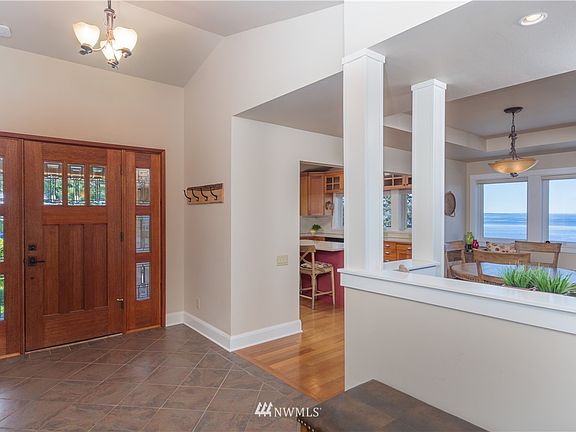 Beautiful solid Mahogany entry door onto ceramic tile with views immediately as you step in. Surprisingly open for a Craftsman.