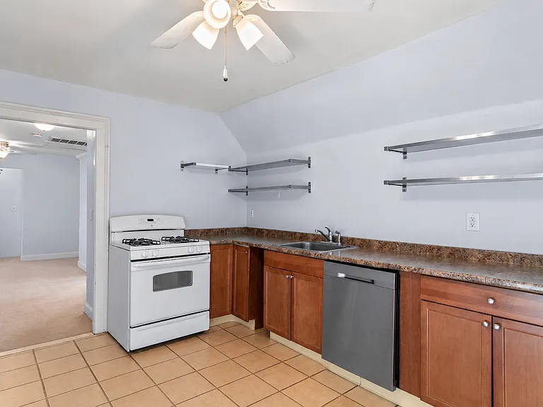 Gas range, ample counter space, storage shelves