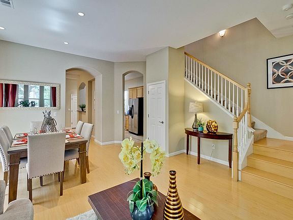 Living room w/ formal dining and stairs to 2nd floor