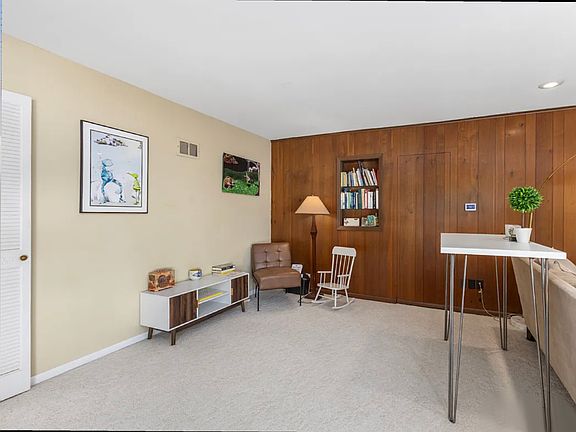 Back living room that looks out to mature trees and recently updated landscaping