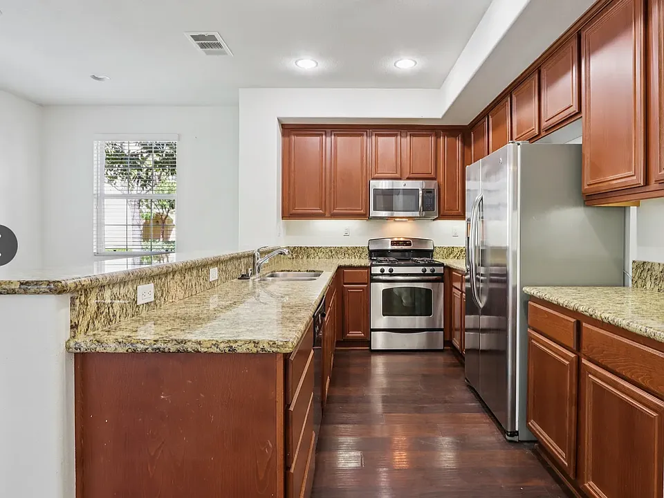 Kitchen-upgraded cabinets, stainless steel appliances, wood flooring.