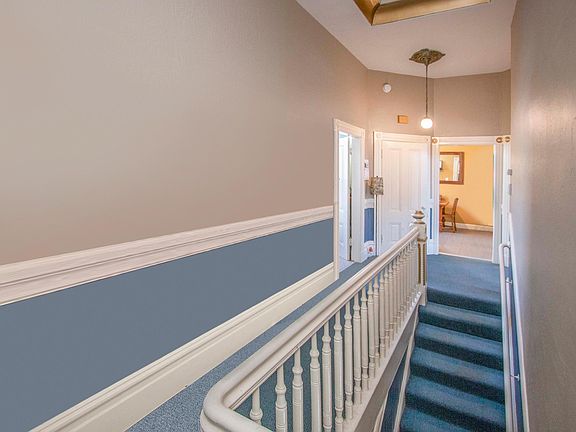 Top of stairs coming into the unit; kitchen entry on right, bath on left