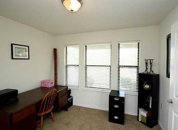 As you enter the home, this is a office space to the right. Plenty of light to work on paperwork here.