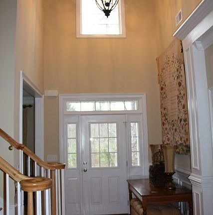 Dramatic 2 Story Foyer with Heavy Moldings & Hardwood Flooring