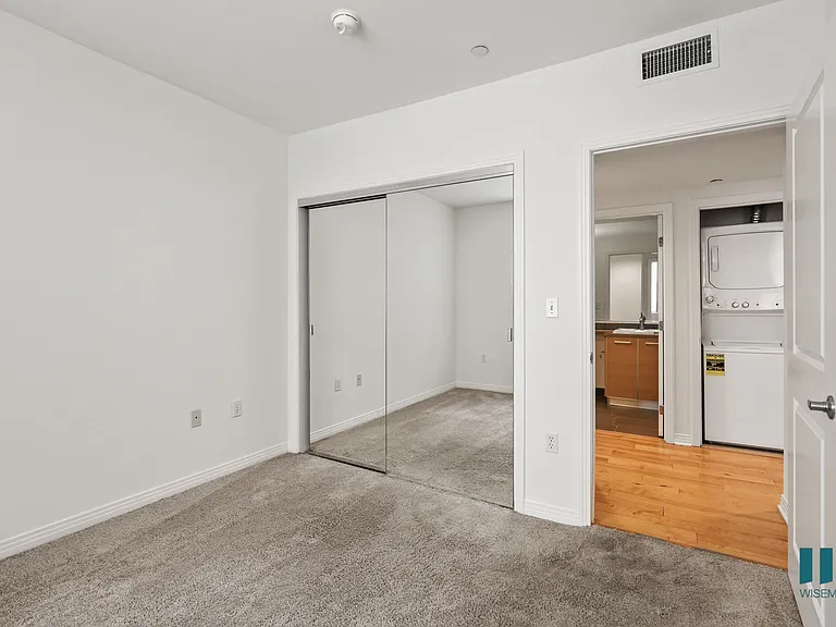 Bedroom with Mirrored Closet and In-Suite Washer & Dryer