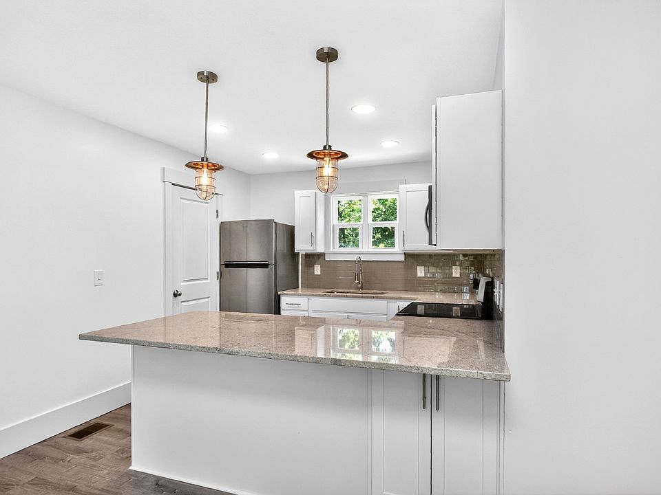 Full size refridgerator with ice maker. Storage on both sides of the island
