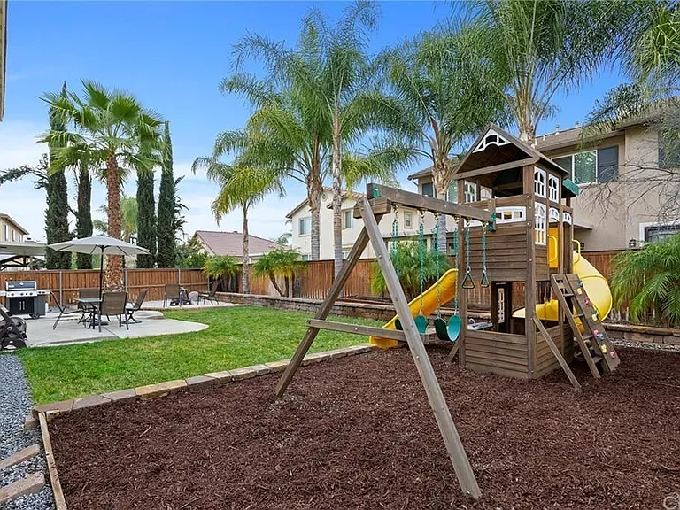 Huge backyard for entertainment; includes kids' playset/area.