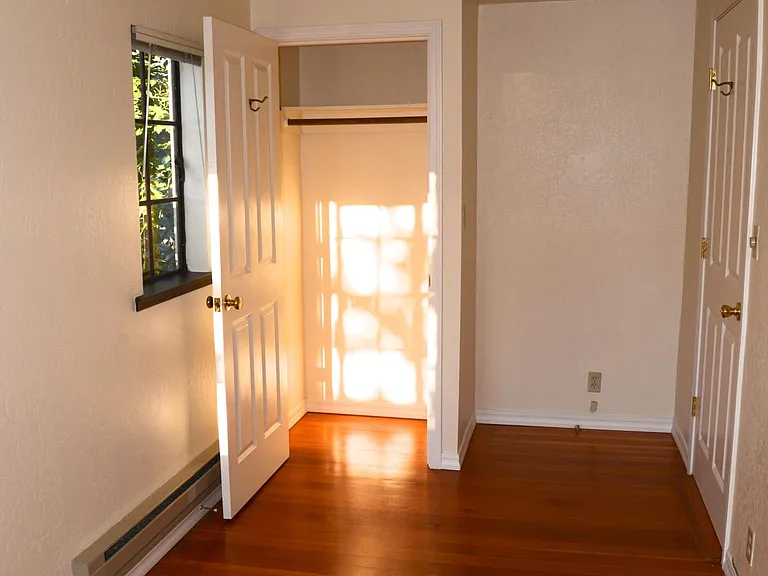 Office with original fir floors and closet/storage area.