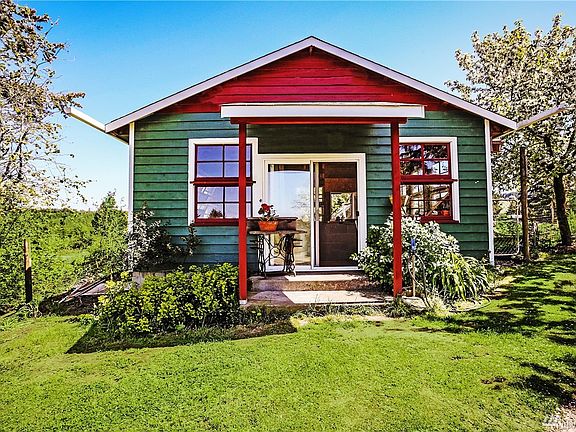 Large greenhouse has a center garden pit and reclaimed windows from the historic Baw Faw grange in Boistfort Valley.  Attached to the back is a spacious chicken house with access for chickens to free-range in the orchard for natural pest control.