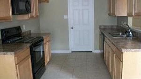 kitchen and through the door is the washer dyer connection and the garage is through this way