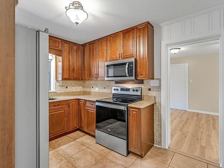 Kitchen with quartz countertops and all new stainless steel appliances.