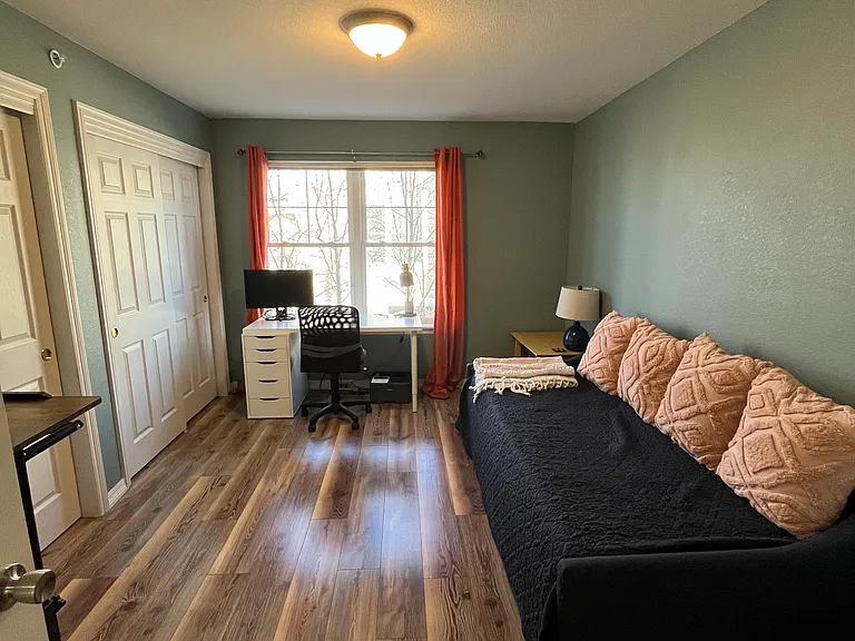 11 x 15 second bedroom/office space with a large built-in closet on the left.