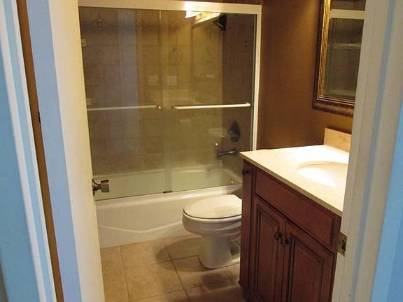 Bathroom with tile flooring and tile enclosure