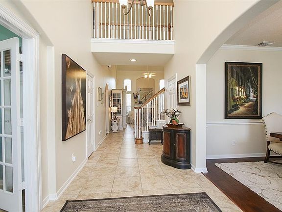 Inviting foyer with high ceilings, recent neutral paint and updated fixtures