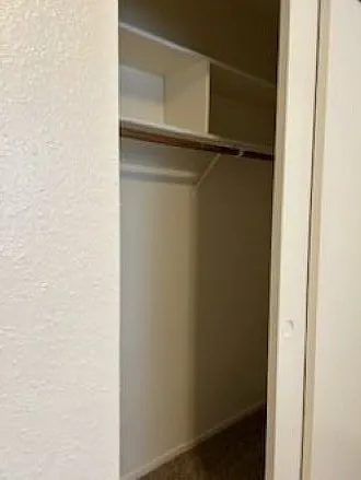 Second bedroom closet with new paint and storage cubbies