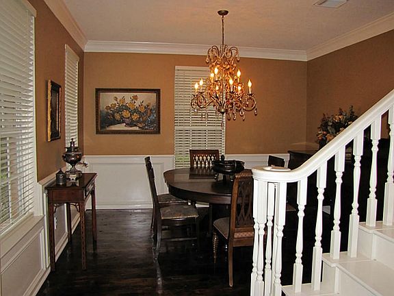 Formal Dining room features crown moldings and rich wood floors.