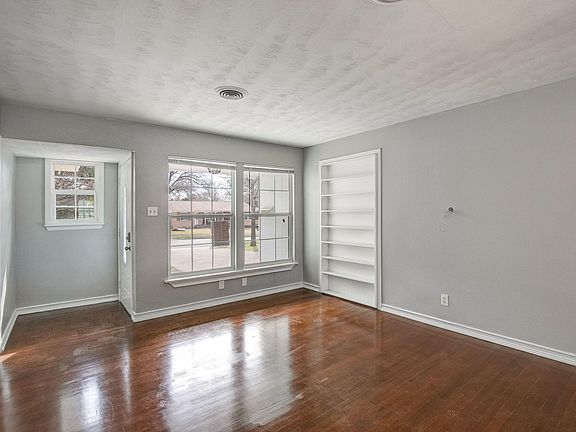 Built-in, custom bookshelf and refinished hardwood!