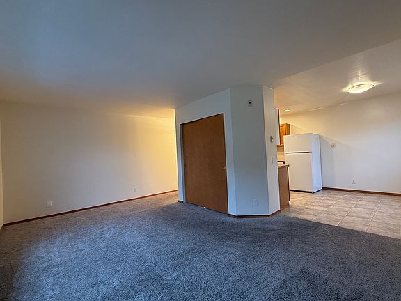 Living area, into kitchen/dining, and coat closet