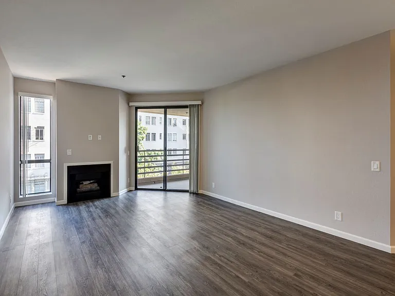 Chelsea Court Two Bedroom Apartment Living Room with Fireplace, Window and Sliders to Balconly