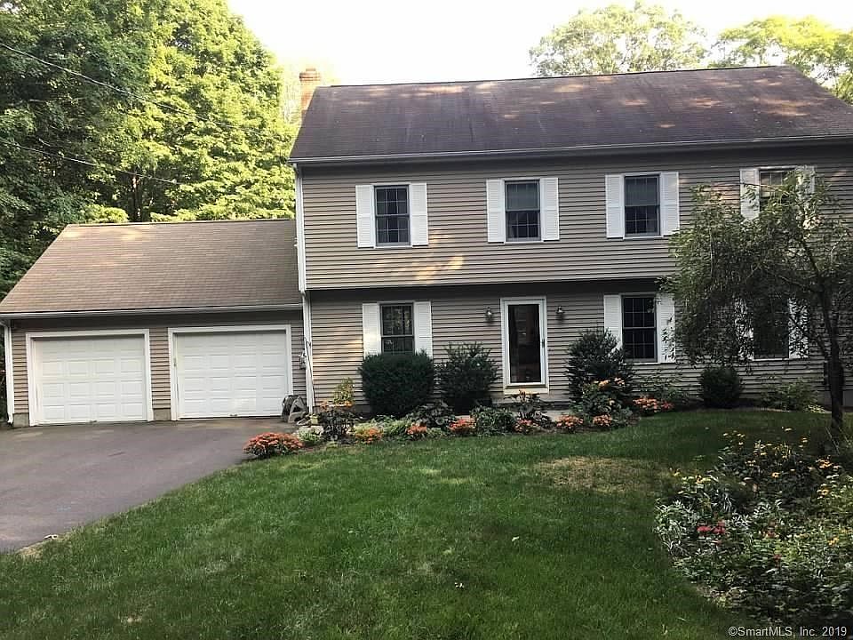 Beautiful colonial set back on a large 2.71 acre lot with lovely gardens.