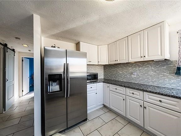 12x24 inch tiles with heated floor in the kitchen! Tile extends into dining room and down the hallway toward the master bedroom 