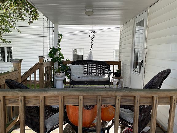 Patio in the back of house facing the fenced backyard.