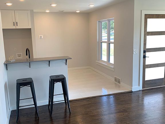 OPEN KITCHEN, DINNING AND LIVING AREA WITH BAR TOP