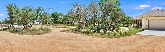 Panoramic view showcasing one of two 14' gates (one automatic), circular drive, and garage. Plenty o