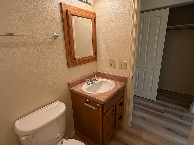 Master bathroom with curved shower curtain rod for more elbow room.
