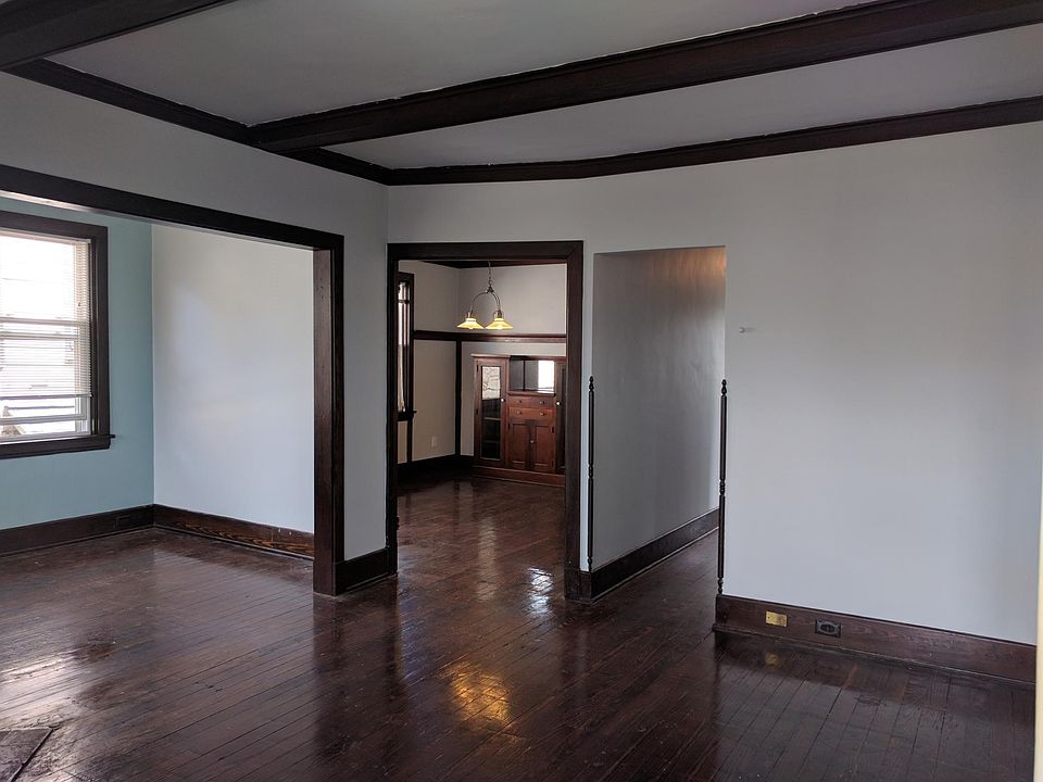 Living room, looking into the sun room at left, dining room center, and hallway right.